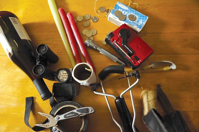Contents of the author’s bug out bag: a hand-crank radio, Leatherman multitool, solar-powered headlamp, strong twine, gaffer tape, hard cash.