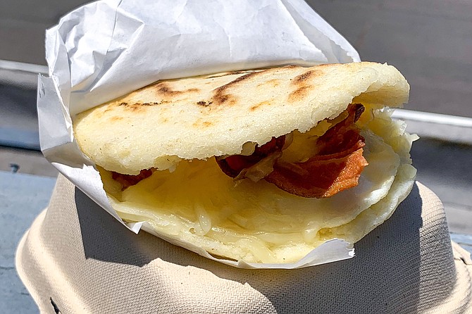 A fried egg, cheese, and bacon arepa 'Americana'