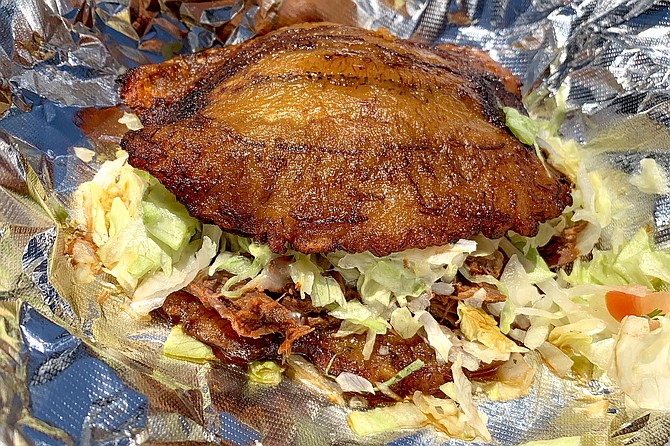 A patacone, sandwich made with fried ripe plantains rather than bread