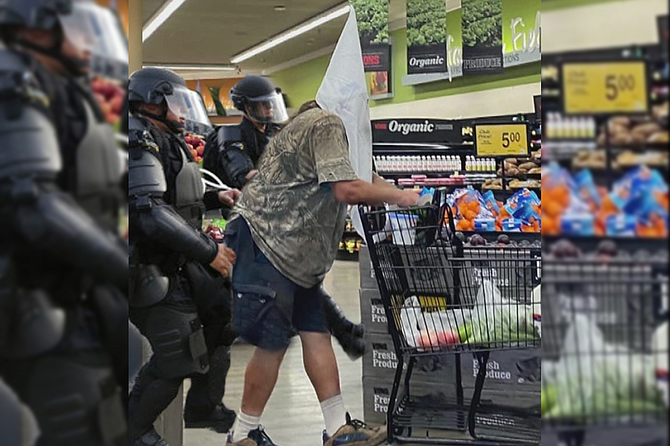 Vons employees, wearing the latest in PPE riot gear, escort the pointy-headed shopper from the premises.