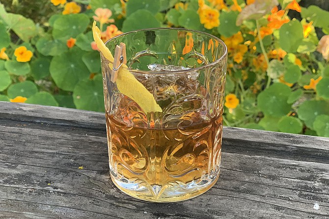 A poured at-home old fashioned from Madison on Park, with clip-on lemon rind