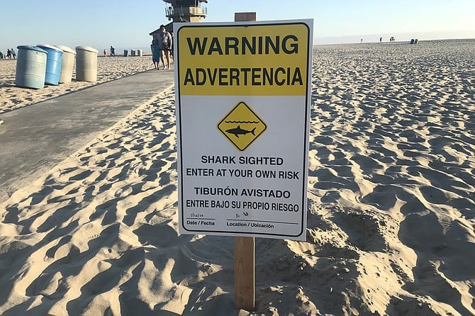 Sign planted in sand at Coronado’s Center Beach