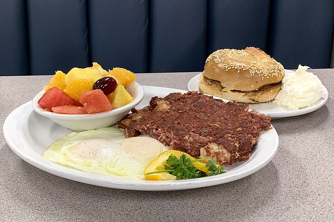 Corned beef hash and eggs, with fruit and a sesame bagel