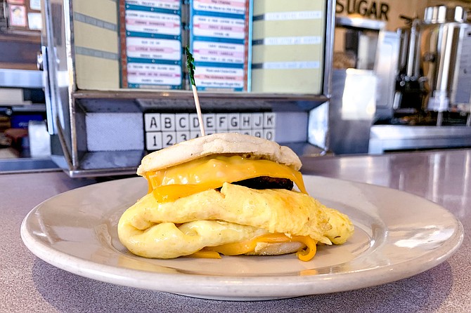 House spicy sausage patty and omelet with American cheese slices, on an English muffin
