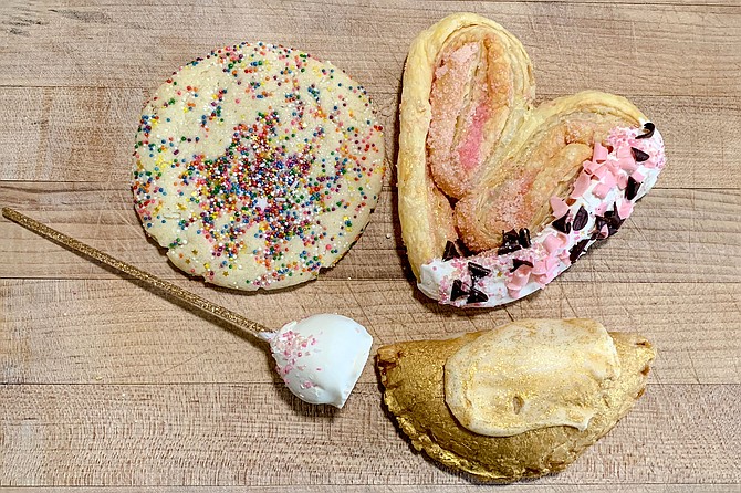 Cochi Dorado pastries include (clockwise from top left) a rainbow sprinkle cookie, rose shaped oreja, pineapple and cream cheese empanada, and mazapan cake pop.