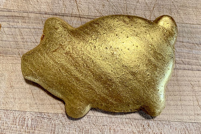 Edible gold luster shines up the signature piloncillo cochita cookie of Cochi Dorado.