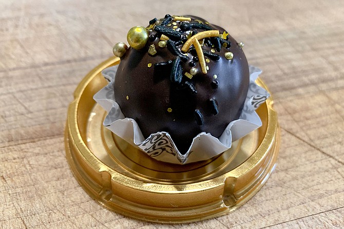 A Oaxacan chocolate and cinnamon cake truffle, with edible gold accents