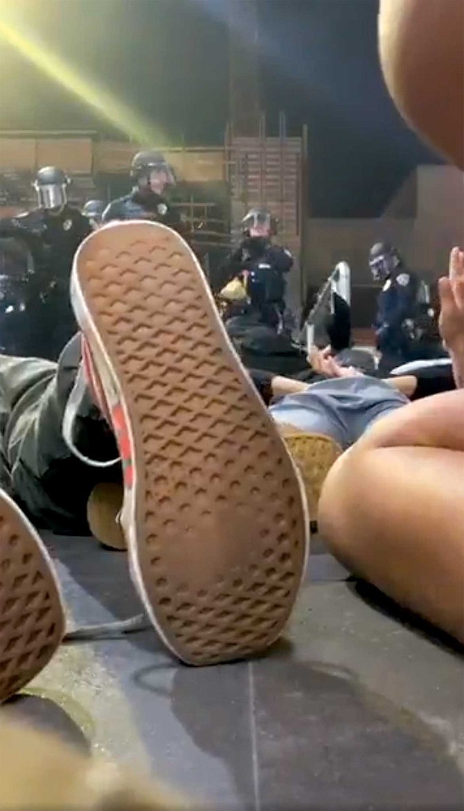 "Get on the ground, now,” yells one of the police officers, “get on the ground on your face, now.”