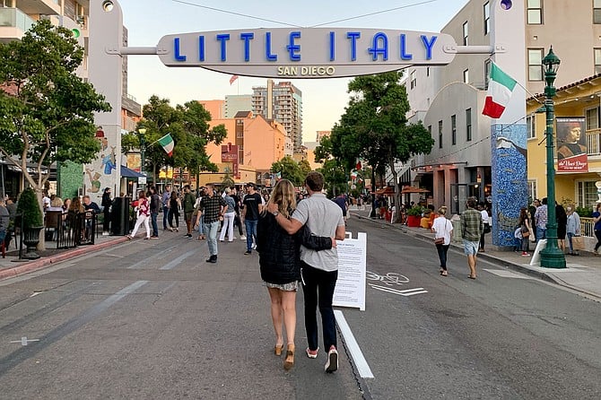 A couple enters Little Italy's carless restaurant zone, as crowds begin to gather.