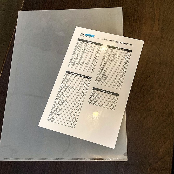 A sushi order sheet kept in a plastic sleeve