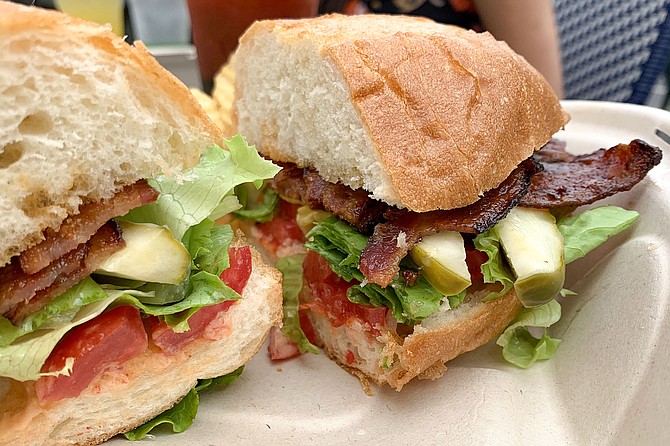 A bacon, lettuce, tomato, and avocado sandwich