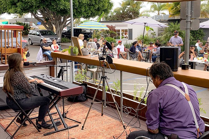 Local musicians perform for diners outside Homestead, in Solana Beach