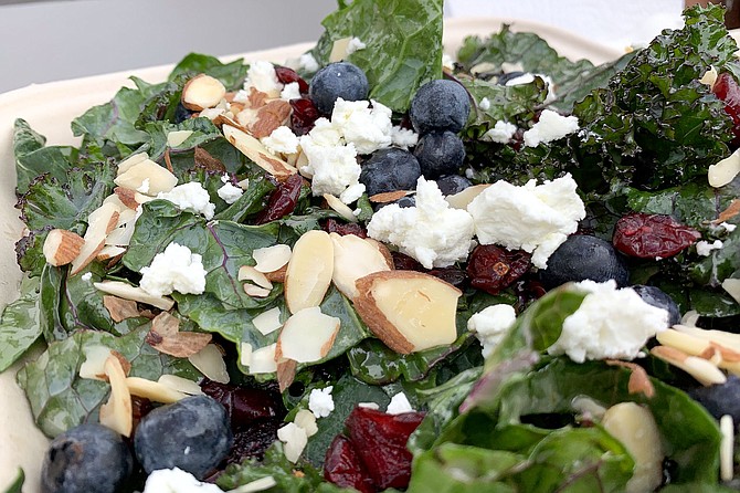 Kale and blueberry salad with goat cheese, cranberries, and slivered almonds