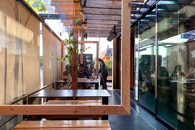 Glass dividers separate booths on the patio of Louisiana Purchase.