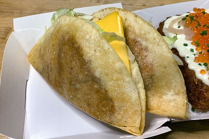 A pair of "Jack in the Crack" tacos, familiar to fast food buffs for their sliced of American cheese.