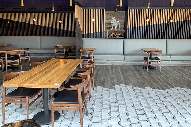 Open dining room meets patio seating, with QR codes at the corner of each table.