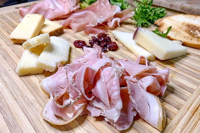 Porchetta is at the forefront of a tasty take-home charcuterie board.
