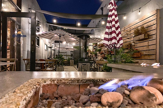 A fire element spruces up the still-open dining patio of opened in 2020 Sicilian restaurant, Rusticucina.