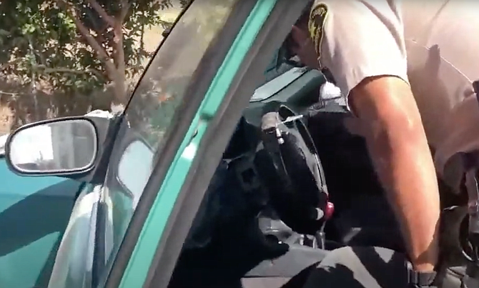 Sheriff's deputy swabbing steering wheel