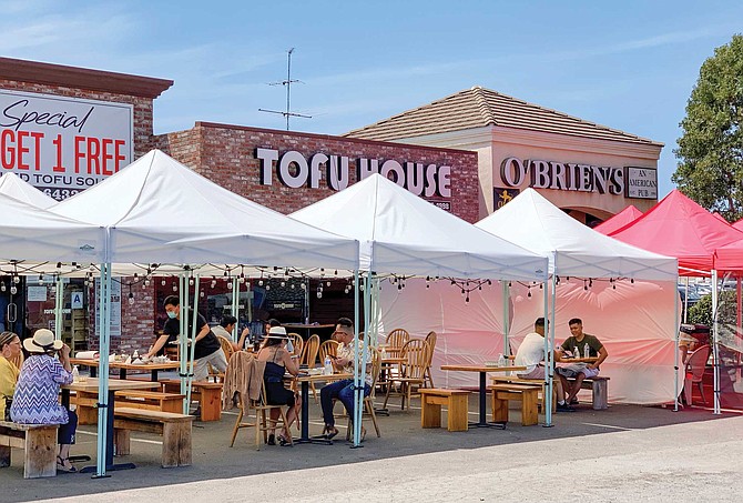 Tofu House couldn’t invest more than five grand to build its outdoor venue. It set up tents and Edison bulb strings, and moved its stone pot scorched tables outside.