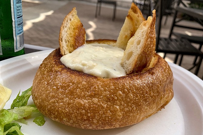 A sourdough bread bowl filled with Pelly's clam chowder