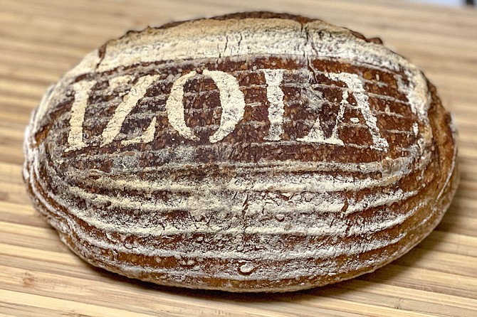 A toasted sesame sourdough loaf made in the home kitchen of a photographer's loft in East Village.