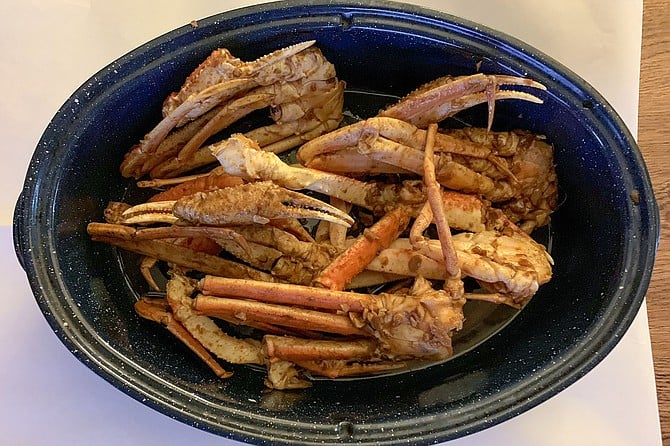 Two pounds of snow crab legs, a take-out order from Shrimp Heads, served at home