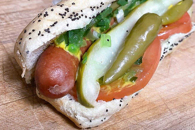 A Chicago hot dog from Lefty's, with pepperoncini, cucumber, relish, tomatoes, mustard, and celery salt, on a poppy seed bun