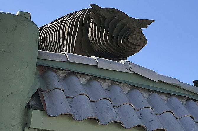 Famous pig sits on roof above The Friendly Tavern’s take-out counter.