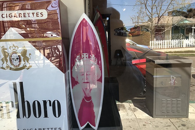 “Queen, seen on surfboard in La Jolla!” But nobody said she was actually surfing.