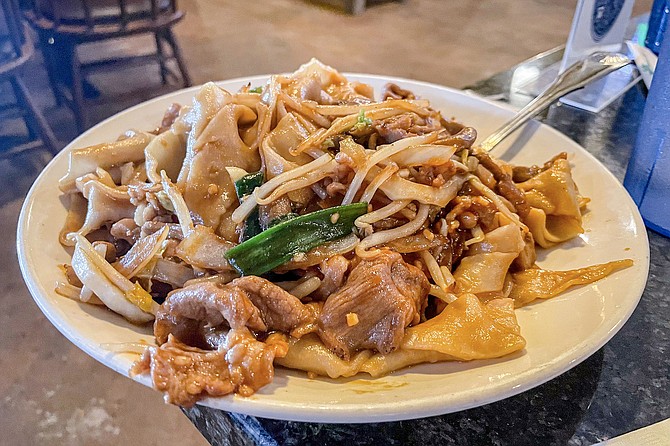 Lamb chow mein, made with the wide house noodles for two bucks extra