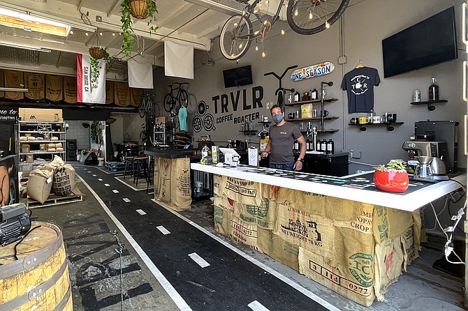 Dan Romeo serves beer, kombucha, and coffee, all made in house, at TRVLR Coffee and One Season Brewing