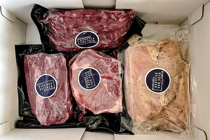 The $64 weeknight power box features vacuum sealed (left to right) hanger steak, duroc pork, lemon pepper chicken, and "butcher bites" (top).