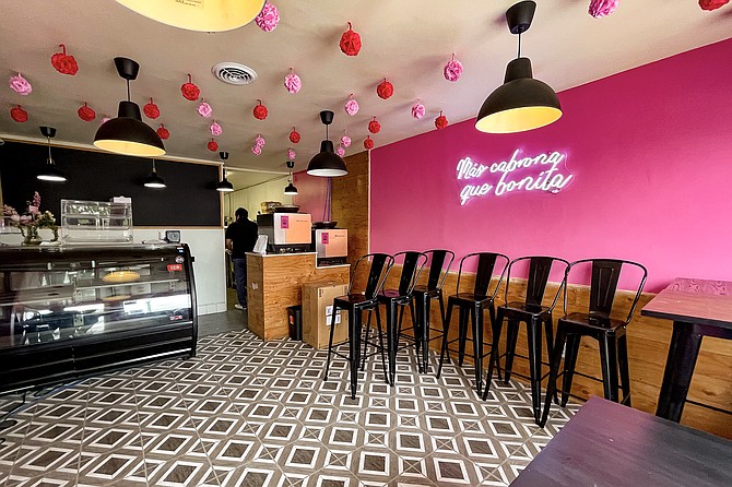 A bright pink interior awaits the reopening coffee and burrito shop's dining room.