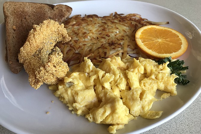 Crumbed cat fish with hash browns, scrambled eggs, $11.