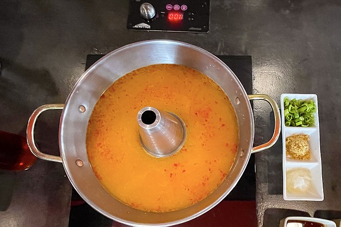 A hot pot of spicy miso broth, ready to boil