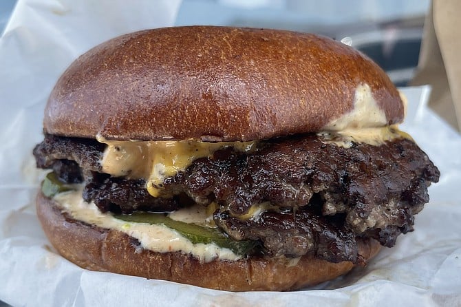 The $18 burger from Swagyu Chop Shop: featuring two smashed burger patties made from a blend of American, Australian, and Japanese wagyu beef.