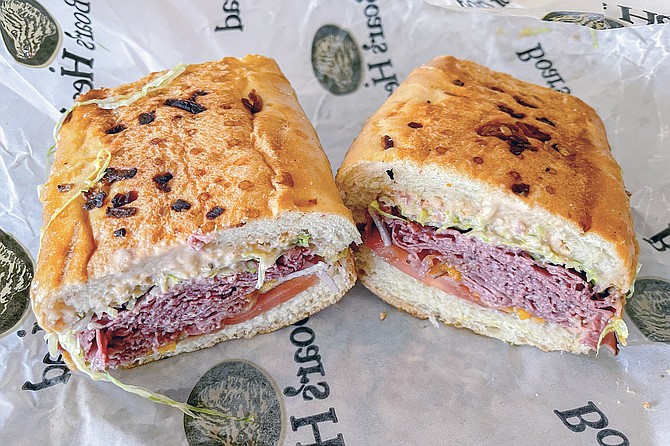 Pastrami and corned beef on a toasted onion roll