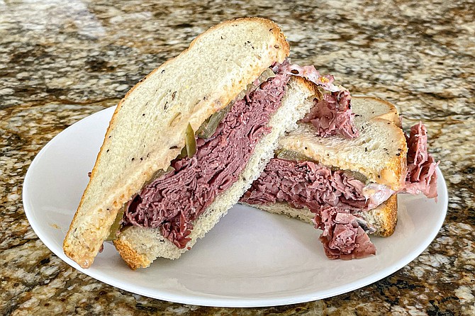 The Double New Yorkers: a pile of steam pastrami with havarti, provolone, pickles, mustard, and thousand island on toasted rye.
