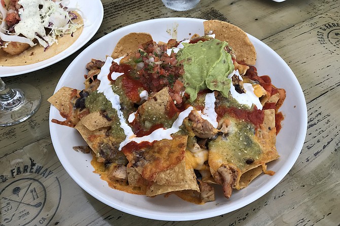 HH nachos are a complete meal. Underneath is a ton of chicken.