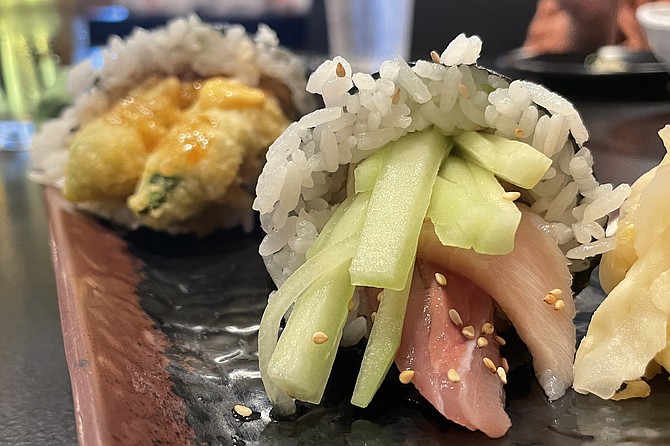 A spicy yellowtail hand roll, and tempura avocado hand roll