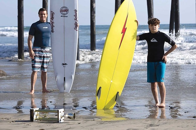 Surf coach Alexander Wells and his student, promising big-wave surfer, 11-year old Ayden Garate.