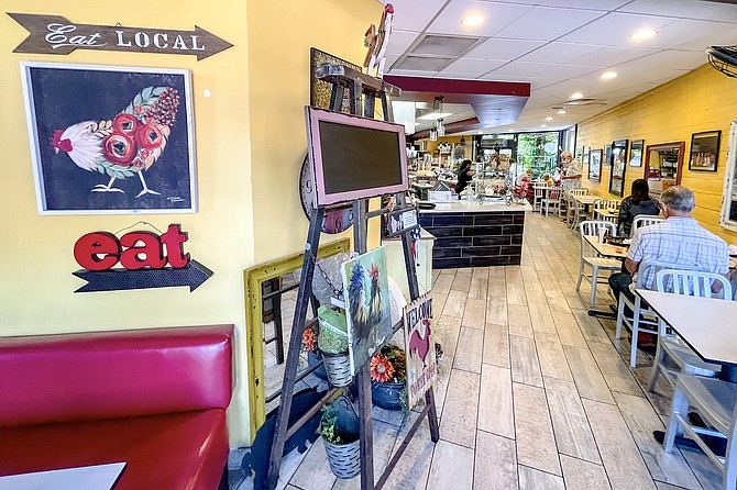 A narrow counter shop, decorated with tchotchkes