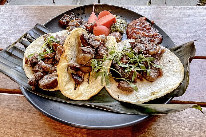 Three ribeye tacos, served with pickled radishes, chimichurri and roasted salsa