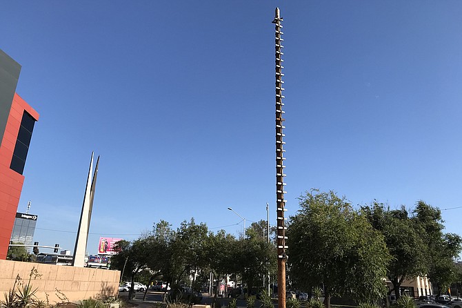 A Tale of Two poles - Independence monument (“The Scissors,” left) and Aztec Voladores’ (“fliers’) pole.
