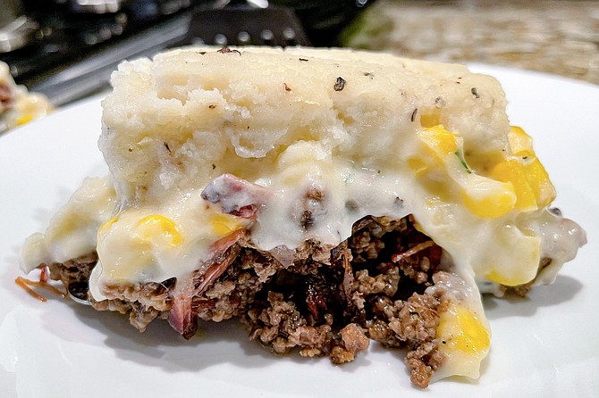 Brisket burnt ends and ground beef topped by sweet cream corn and peppery mashed potatoes
