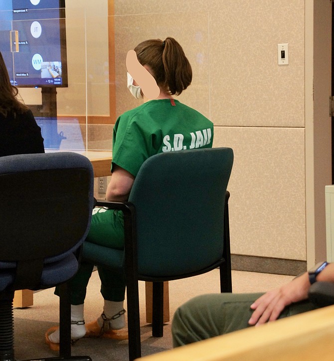 Malissa James in courtroom. Judge ordered her face obscured. Photo by Eva Knott.