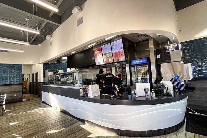 A counter shop backed by rotisseries