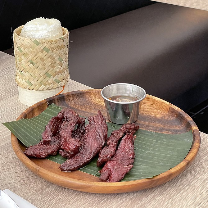 Lao beef jerky, served with a bag of sticky rice