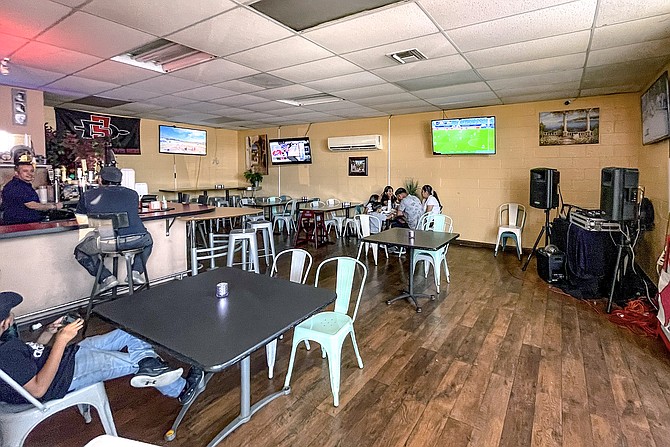 A bar in the dining room tunes its TVs to sports; turntables make it a music venue.